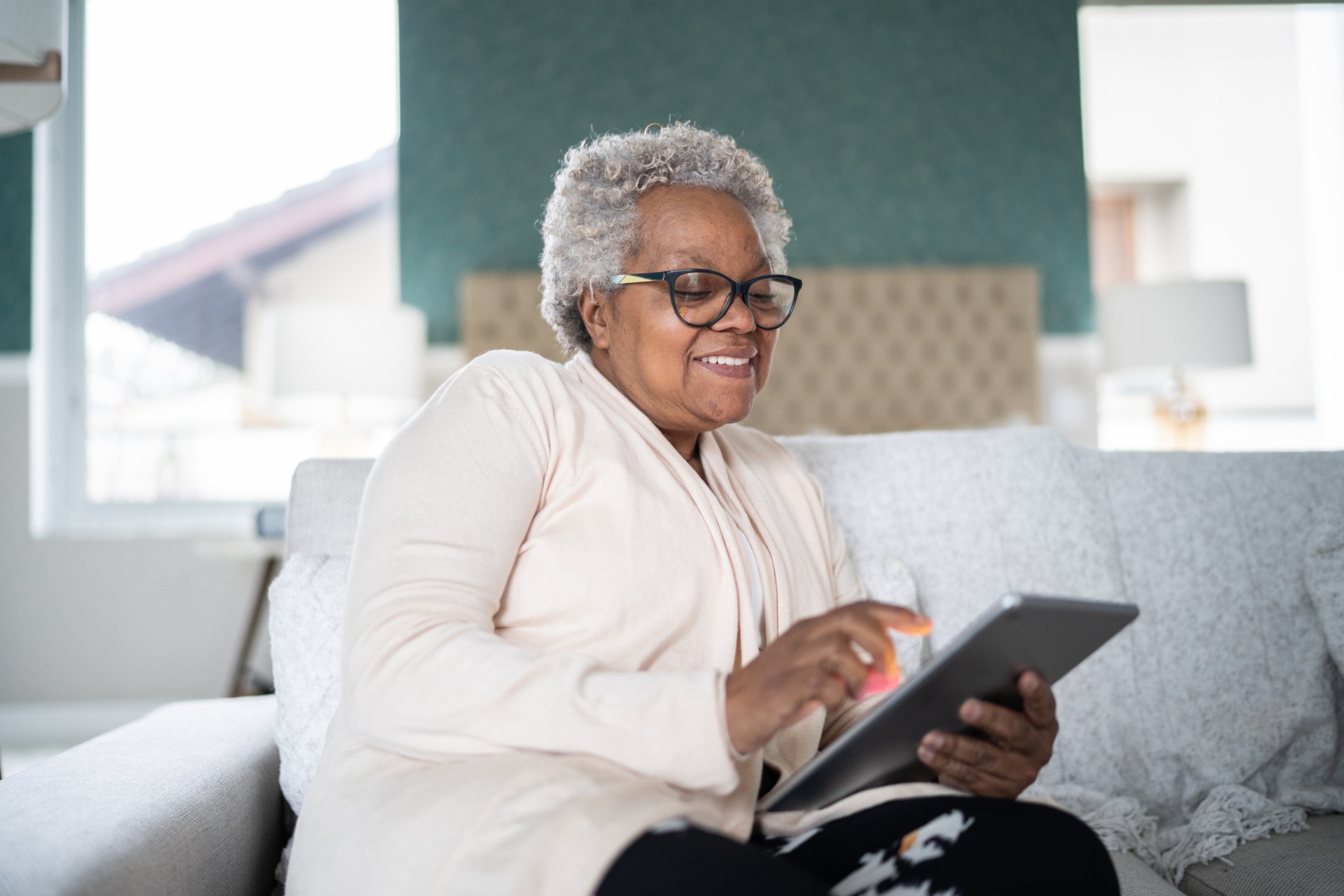 A woman reading updates on a tablet
